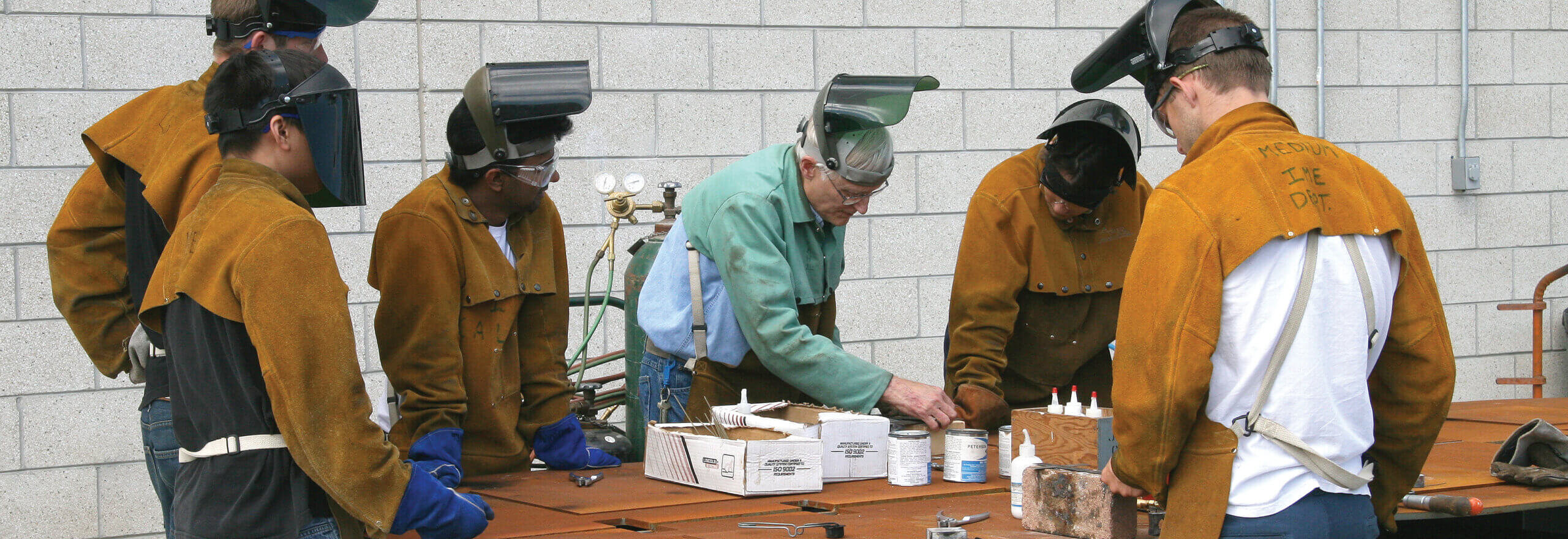 Group of six preparing to weld