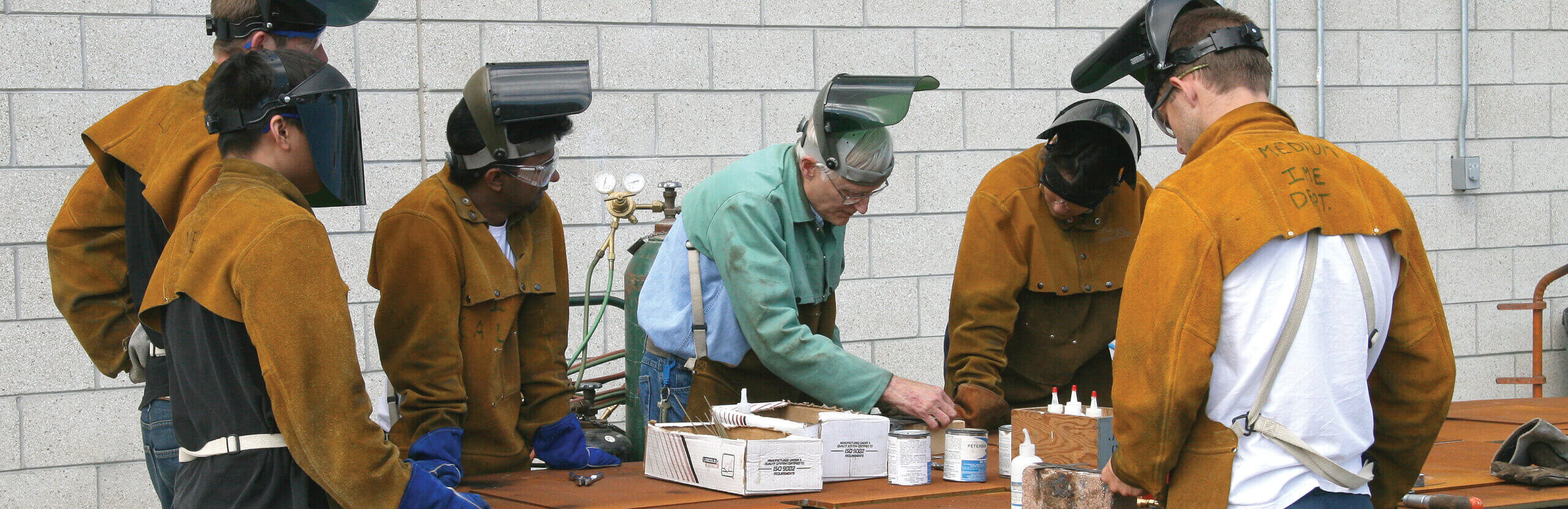 Group of six preparing to weld